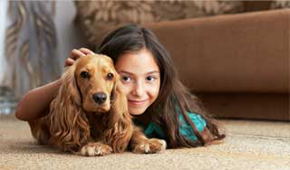 child and dog relaxing on floor